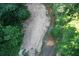Aerial view of a creek running along a sandy path at 6675 Millwood Rd, Cumming, GA 30041