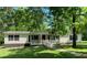 Charming single story home with front porch and mature shade trees at 6675 Millwood Rd, Cumming, GA 30041