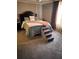 Comfortable bedroom featuring carpet, a pillow with the word 'Grace' written on it, and steps for pets at 6675 Millwood Rd, Cumming, GA 30041