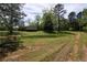 Spacious yard with mature trees providing shade and privacy to the home at 6675 Millwood Rd, Cumming, GA 30041