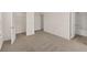 A spacious bedroom featuring neutral carpeting, a walk-in closet, and an ensuite bath at 1159 Blue Juniper Cir, Loganville, GA 30052