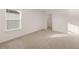 Bedroom with neutral carpeting features a window and closet nearby at 1159 Blue Juniper Cir, Loganville, GA 30052