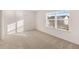 Sunlit bedroom with a bright window and plush carpeting at 1159 Blue Juniper Cir, Loganville, GA 30052