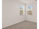 Cozy bedroom with carpet flooring and a view of the outdoors through two large windows at 1159 Blue Juniper Cir, Loganville, GA 30052