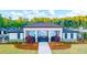 Community clubhouse with ample seating, lovely landscaping, and a covered patio, a great place to gather at 1159 Blue Juniper Cir, Loganville, GA 30052