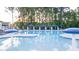 Large swimming pool with shaded cabanas, lounge chairs, and umbrellas, perfect for relaxation and recreation at 1159 Blue Juniper Cir, Loganville, GA 30052