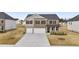 Beautiful two-story home featuring a brick and stone facade, two-car garage, and well-maintained landscaping at 1159 Blue Juniper Cir, Loganville, GA 30052