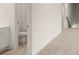 Hallway with plush carpeting featuring a bathroom to the left at 1159 Blue Juniper Cir, Loganville, GA 30052