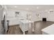 Kitchen with central island, fireplace in living room, and stainless appliances at 1159 Blue Juniper Cir, Loganville, GA 30052