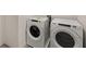 Modern laundry room features white washer and dryer at 1159 Blue Juniper Cir, Loganville, GA 30052