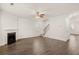 Large living room with fireplace, staircase, ceiling fan, and hardwood floors at 1159 Blue Juniper Cir, Loganville, GA 30052