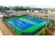 Community tennis courts with blue and green surface, surrounded by fencing and landscaping for privacy at 1159 Blue Juniper Cir, Loganville, GA 30052