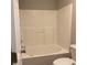 Clean, white tiled bathtub and shower combination at 233 Winterville Dr, Rockmart, GA 30153