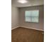 Neutral bedroom featuring plush carpeting and a window for natural light at 233 Winterville Dr, Rockmart, GA 30153