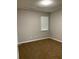 Neutral bedroom featuring plush carpeting and a window for natural light at 233 Winterville Dr, Rockmart, GA 30153