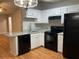 Eat-in kitchen features granite countertops, white cabinets and black appliances at 233 Winterville Dr, Rockmart, GA 30153