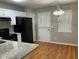 Eat-in kitchen features granite countertops, white cabinets and black appliances at 233 Winterville Dr, Rockmart, GA 30153