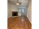 Open living room with brick fireplace, ceiling fan and hardwood floors at 233 Winterville Dr, Rockmart, GA 30153