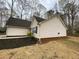A view of the side of the home with clean vinyl siding, dark roof and manicured flower beds at 233 Winterville Dr, Rockmart, GA 30153