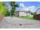 A spacious backyard showcasing a home, verdant lawn and convenient gravel space at 3483 Addilyn Ne Ct, Marietta, GA 30066