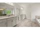 Bright bathroom featuring double vanity sinks, granite countertop, and tile flooring at 3483 Addilyn Ne Ct, Marietta, GA 30066