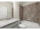 Well-lit bathroom features a granite countertop, white cabinets, and a tiled shower over the tub at 3483 Addilyn Ne Ct, Marietta, GA 30066