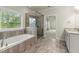 Elegant bathroom featuring a separate shower and tub, with stylish tile and vanity at 3483 Addilyn Ne Ct, Marietta, GA 30066