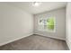 Bright carpeted bedroom featuring a window with blinds and a neutral wall color at 3483 Addilyn Ne Ct, Marietta, GA 30066