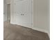 Carpeted bedroom featuring neutral walls, trim, and a double door closet at 3483 Addilyn Ne Ct, Marietta, GA 30066