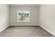 Neutral carpeted bedroom with white trim and a window providing natural light at 3483 Addilyn Ne Ct, Marietta, GA 30066