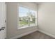 Bright carpeted bedroom featuring a window with blinds, neutral walls, base trim and nearby door at 3483 Addilyn Ne Ct, Marietta, GA 30066