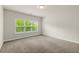 Cozy bedroom featuring neutral carpet and a window offering a view of the outdoors at 3483 Addilyn Ne Ct, Marietta, GA 30066