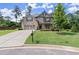 Beautiful two-story home showcasing lush front lawn, mature trees, and brick and stone facade at 3483 Addilyn Ne Ct, Marietta, GA 30066