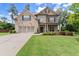 Inviting two-story home with a two-car garage, stone accents, and professionally landscaped front yard at 3483 Addilyn Ne Ct, Marietta, GA 30066