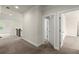 Carpeted hallway with white trim and doorways, showing access to multiple rooms at 3483 Addilyn Ne Ct, Marietta, GA 30066
