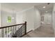 Hallway with carpeted floors, white walls, and a view of the staircase at 3483 Addilyn Ne Ct, Marietta, GA 30066