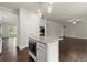 Open-concept kitchen with stainless appliances, an island, and white cabinetry offers modern functionality at 3483 Addilyn Ne Ct, Marietta, GA 30066