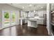 Bright kitchen with stainless appliances, white cabinets, and a backyard view through French doors at 3483 Addilyn Ne Ct, Marietta, GA 30066