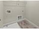 Laundry room with tile floors, trim, utility connections, and rack for storage at 3483 Addilyn Ne Ct, Marietta, GA 30066