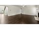Open living room featuring dark hardwood floors, staircase, and fireplace offers comfortable living space at 3483 Addilyn Ne Ct, Marietta, GA 30066