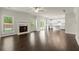Spacious living room with fireplace, hardwood floors, and open floor plan to kitchen at 3483 Addilyn Ne Ct, Marietta, GA 30066