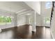Spacious living room with hardwood floors, modern lighting, and large windows offering plenty of natural light at 3483 Addilyn Ne Ct, Marietta, GA 30066