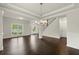 Bright living room with hardwood flooring, staircase access, and a view of the front yard at 3483 Addilyn Ne Ct, Marietta, GA 30066