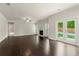 Bright living room with fireplace, hardwood floors, and French doors to backyard at 3483 Addilyn Ne Ct, Marietta, GA 30066