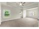 Spacious main bedroom with carpet, tray ceiling, and large windows at 3483 Addilyn Ne Ct, Marietta, GA 30066