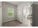 Walk-in closet with wire shelving, neutral carpeting, and natural light from the window at 3483 Addilyn Ne Ct, Marietta, GA 30066