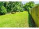 Spacious backyard with a long wooden fence and lush greenery providing ample space and privacy for outdoor activities at 391 Buchanan St, Dallas, GA 30157
