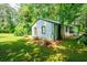 Charming exterior view of a well-maintained home with lush green lawn and mature trees in a serene setting at 391 Buchanan St, Dallas, GA 30157