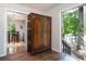 Cozy foyer with hardwood floors, antique cabinet, with an open view to a dining area and views to the exterior at 391 Buchanan St, Dallas, GA 30157