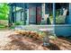 Charming front porch with outdoor seating, plants, and a decorative bird bath, adding to its appeal at 391 Buchanan St, Dallas, GA 30157
